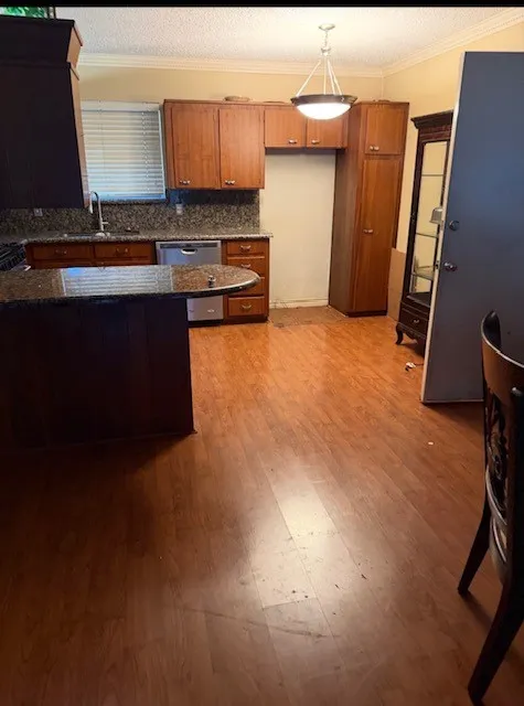 Wood-finish flooring, integrated sink with a stainless steel faucet, and recessed lighting