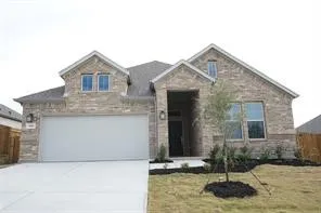 Brick veneer exterior with gabled roof lines, attached two-car garage, concrete driveway, and front landscaping