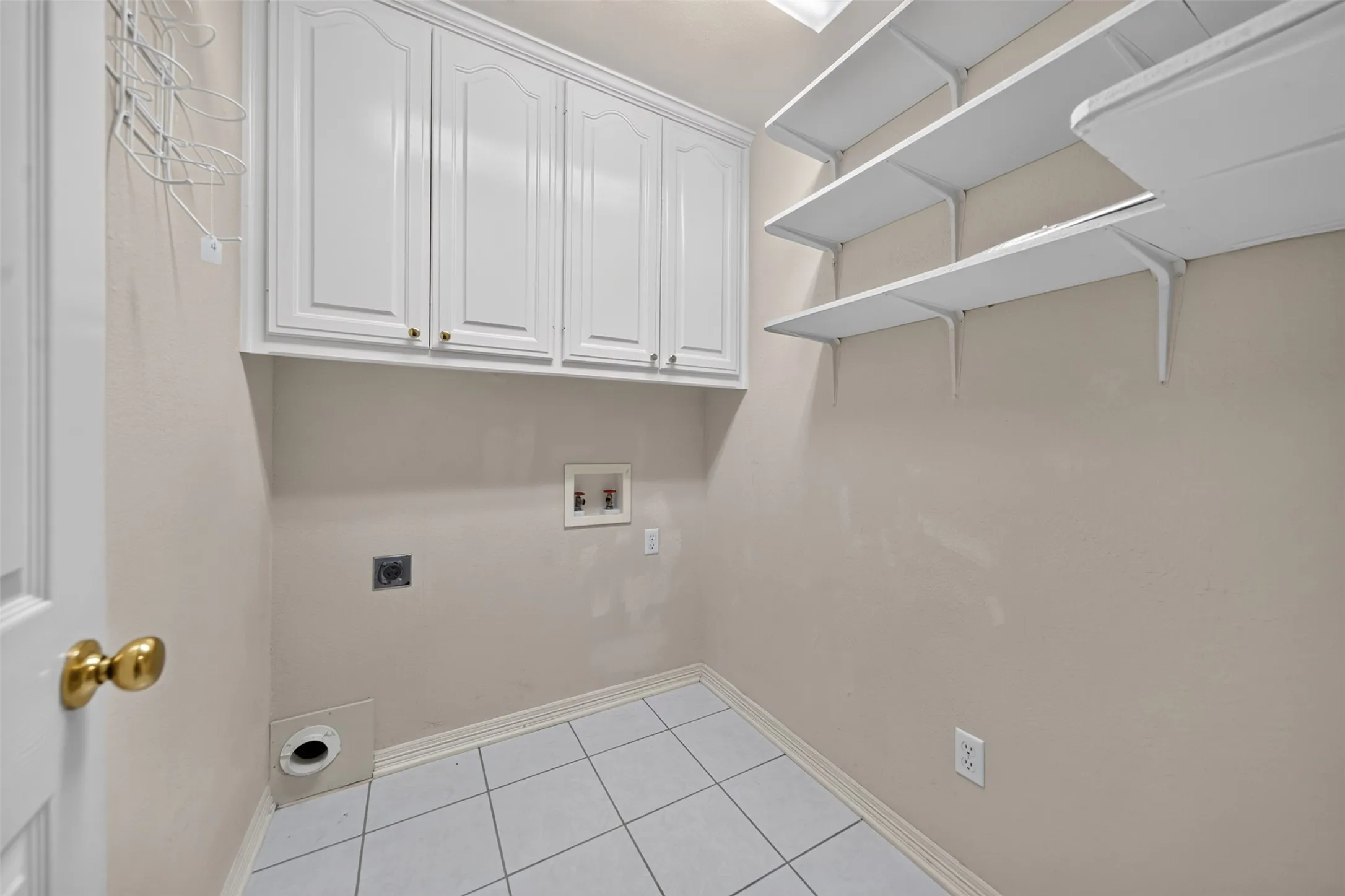 Laundry room features additional storage just off of the kitchen and garage.