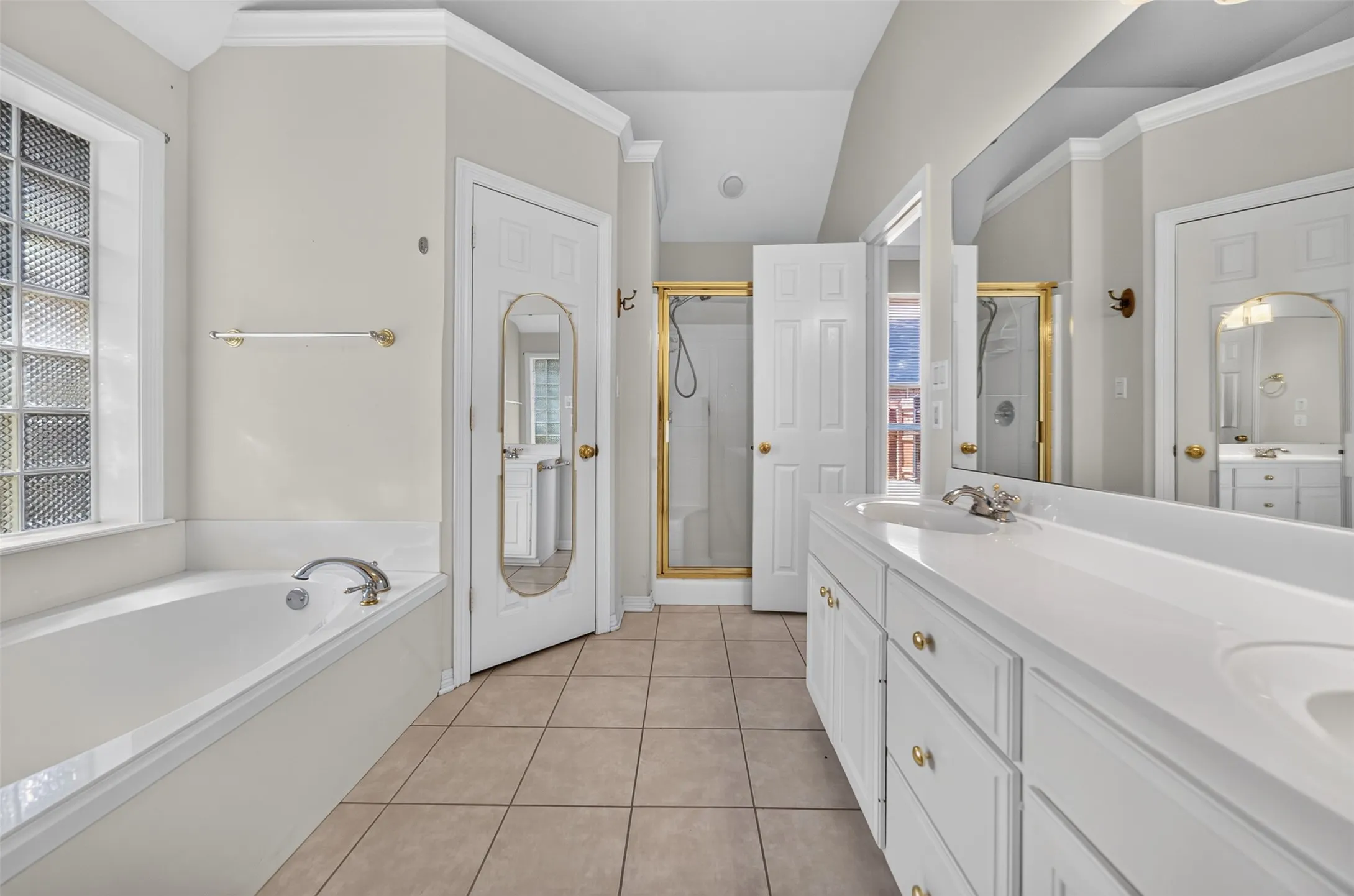 Full view of the Larger Bath looking through the batharea.  Notice the double sinks and shower area.