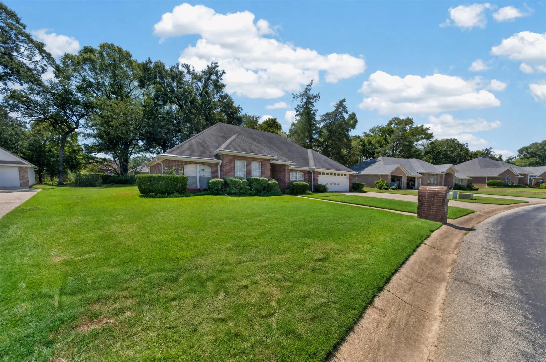 View from the West side of the home looking back toward the entrance area of the subdivision.  Notice the Bricked mailbox!!