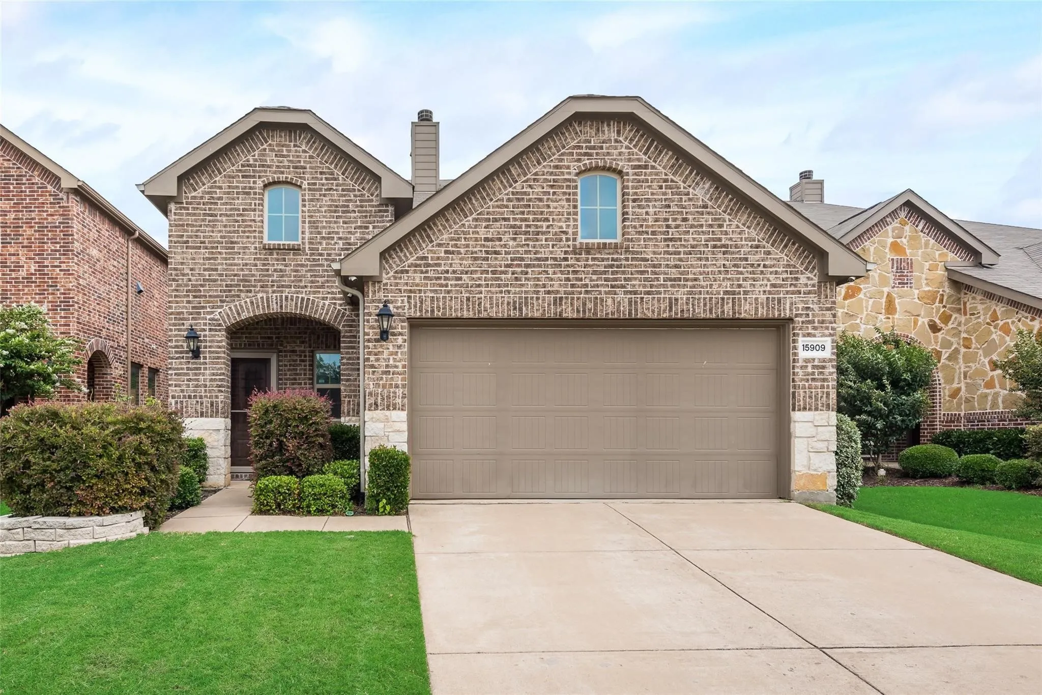 Brick and stone facade with an arched entry