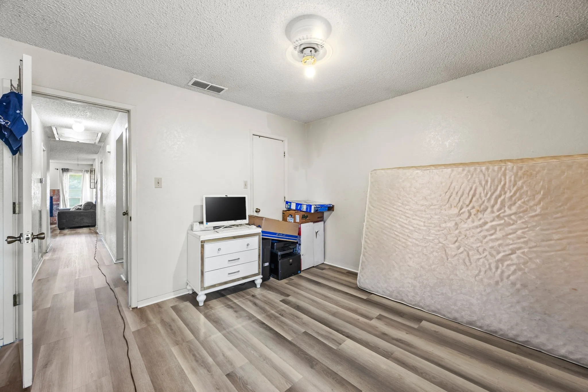 Wood-finish flooring throughout the room and hallway