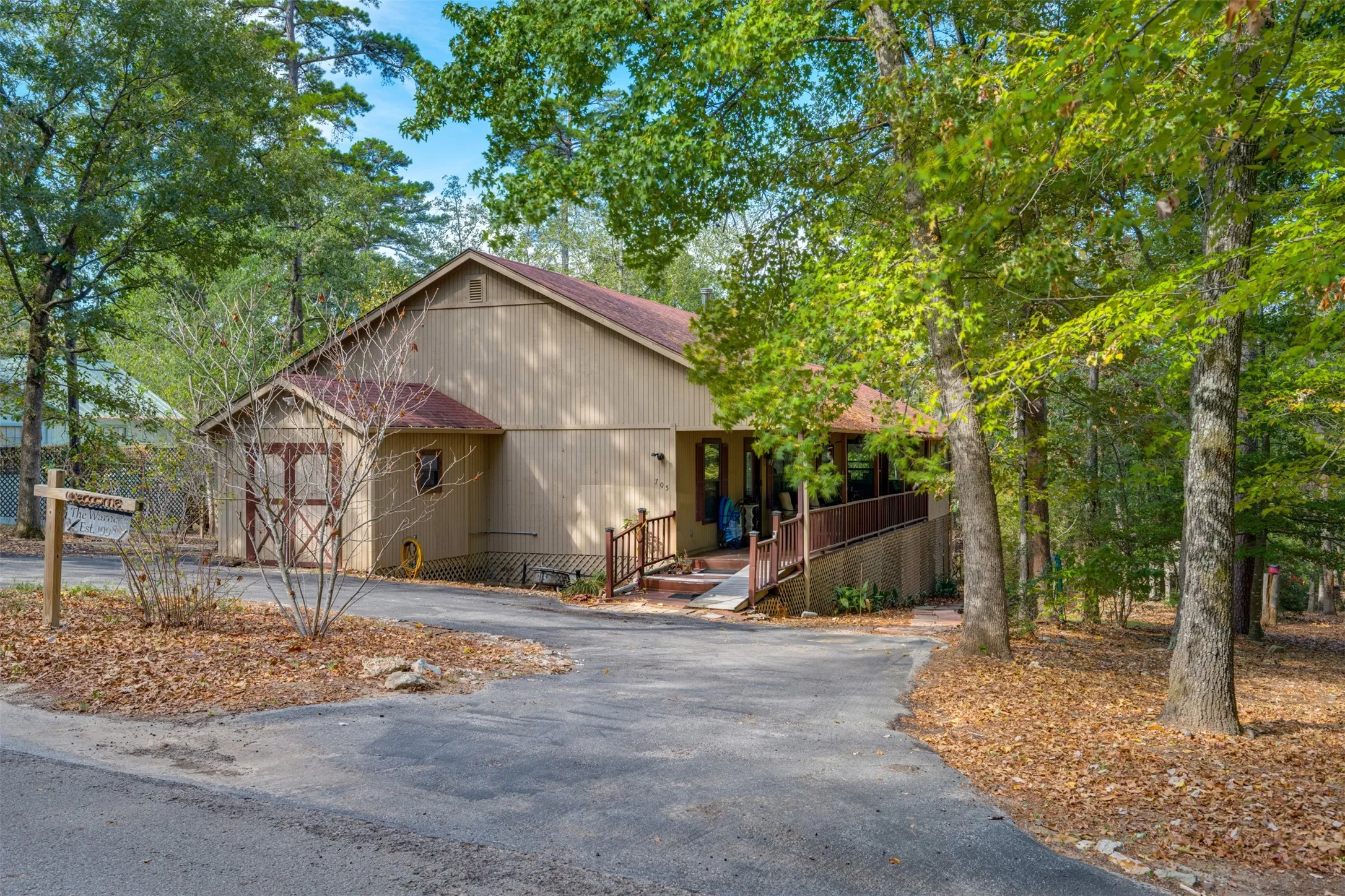 Property exterior with a multi-level wood deck and ramp access