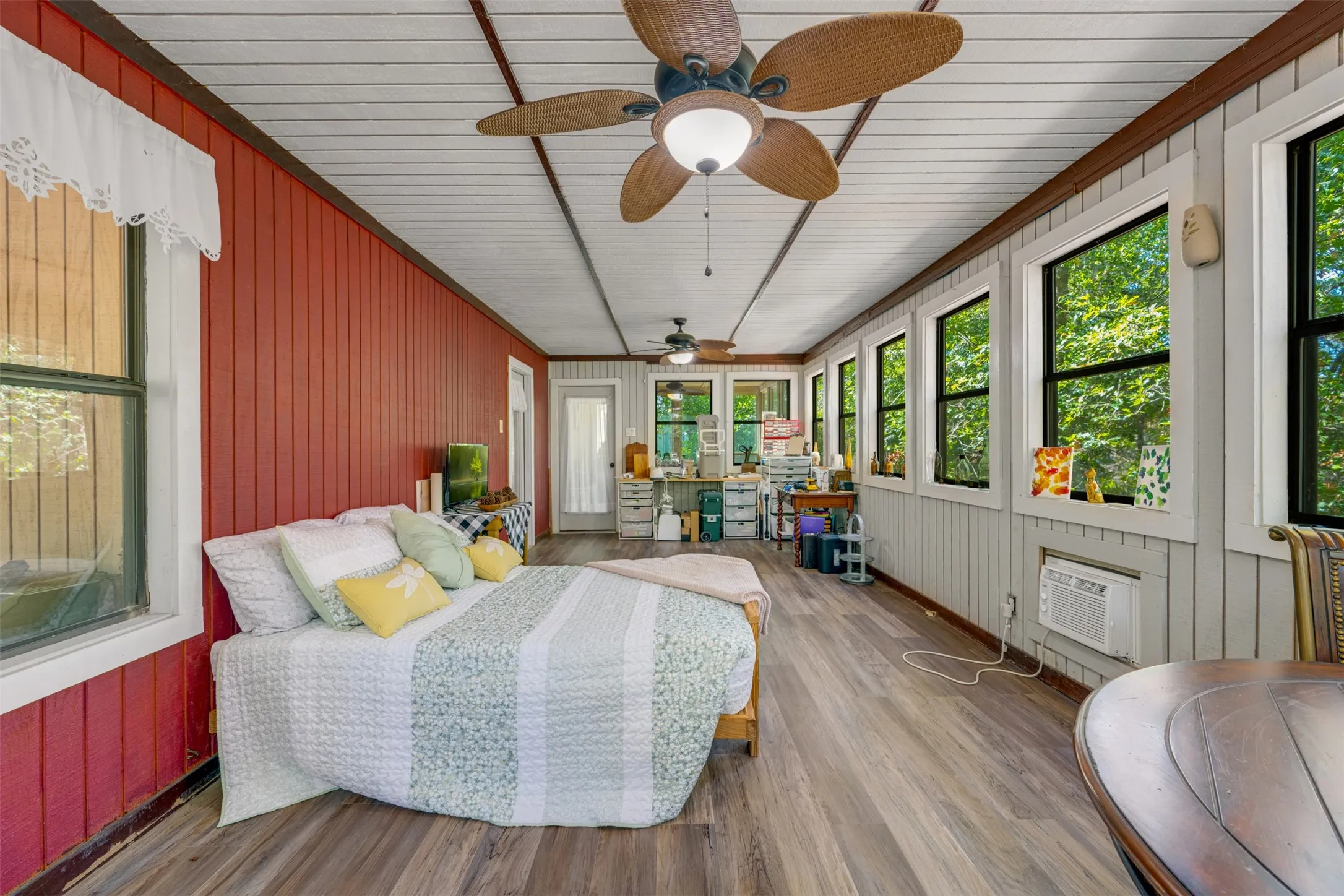 Wood-finish flooring, white paneled ceiling, and multiple windows
