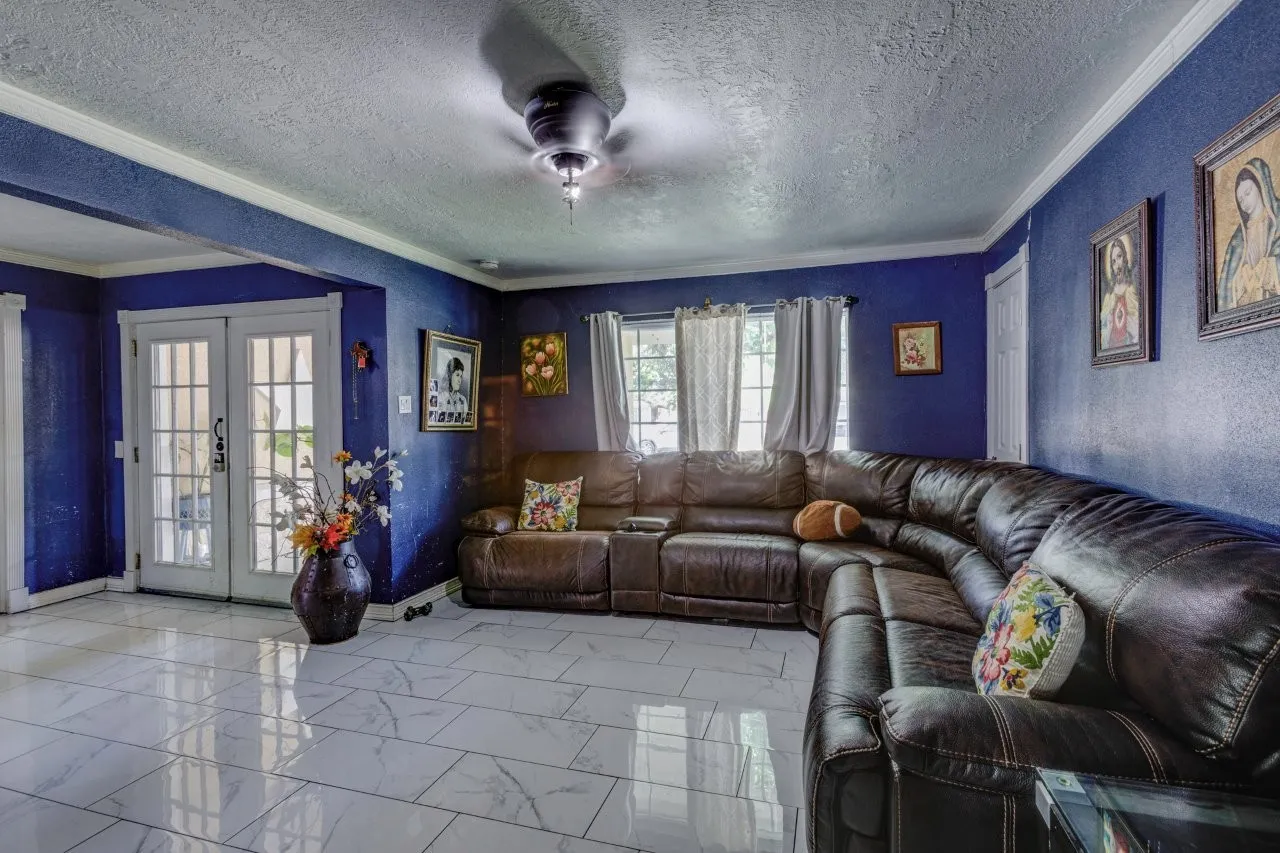 Recessed ceiling fan with light fixture, double French doors, white trim, and rectangular tile flooring