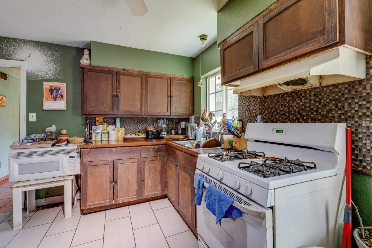 Wood-finish cabinetry paired with a mosaic tile backsplash