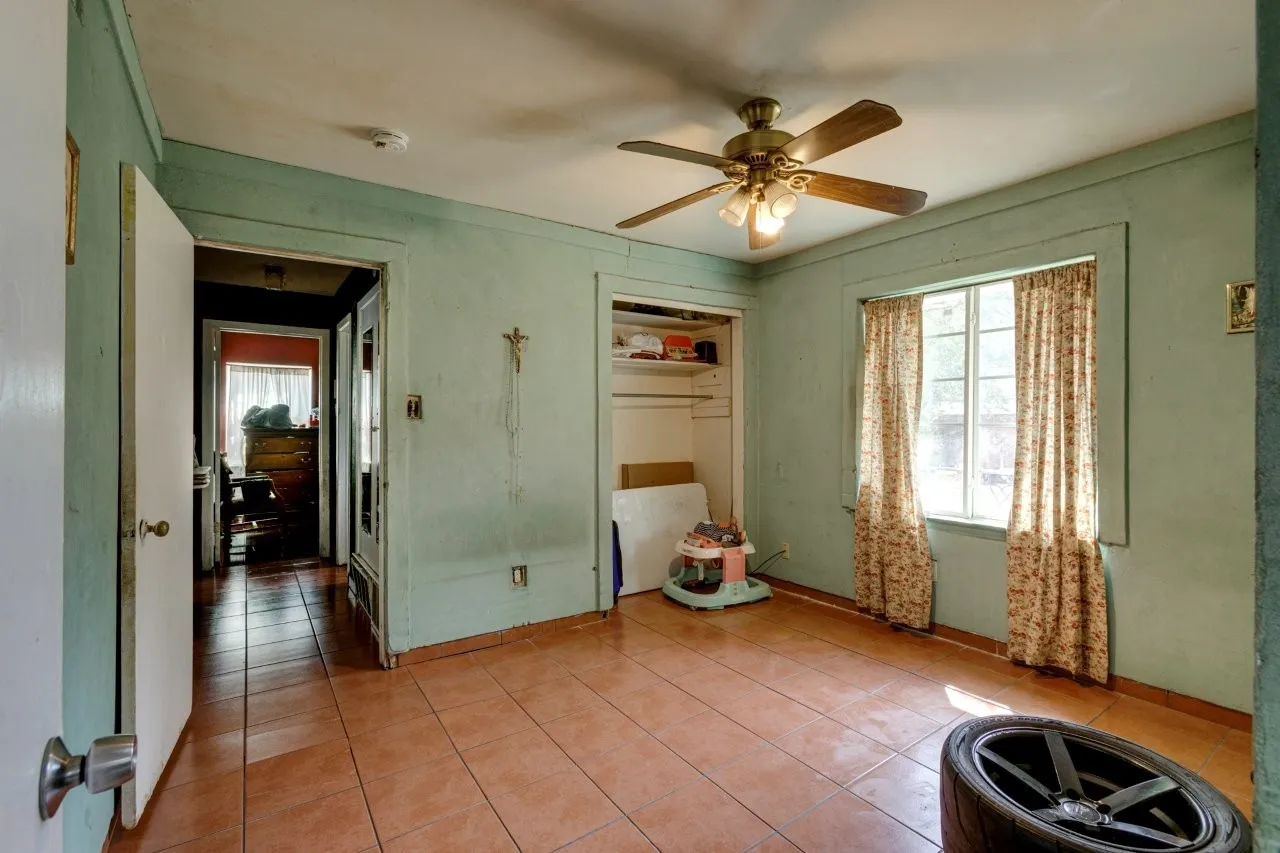 Tile flooring, ceiling fan with integrated lighting, built-in open shelving, single window