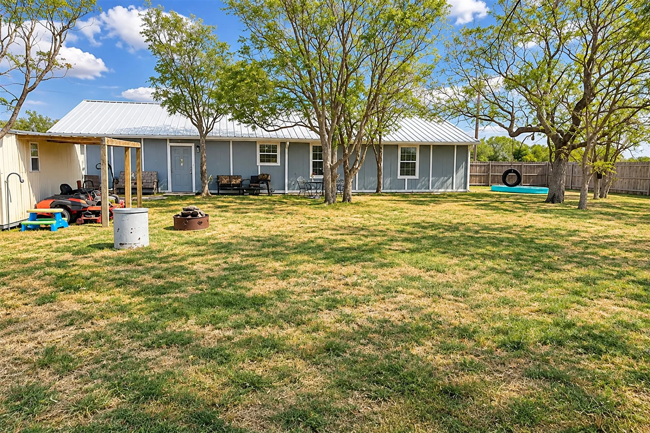 backyard with storage shed and attached awning/