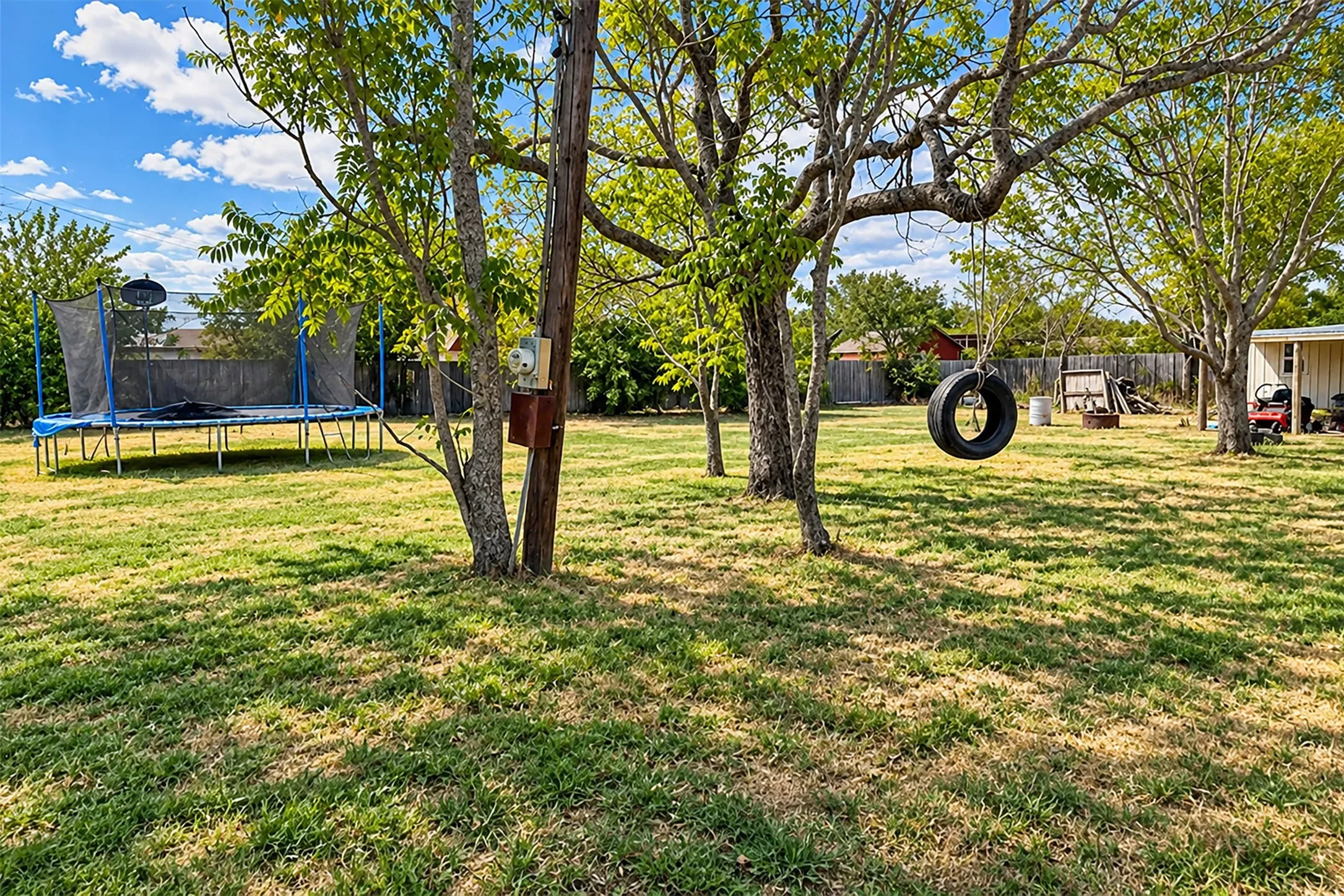 far left side of the backyard.