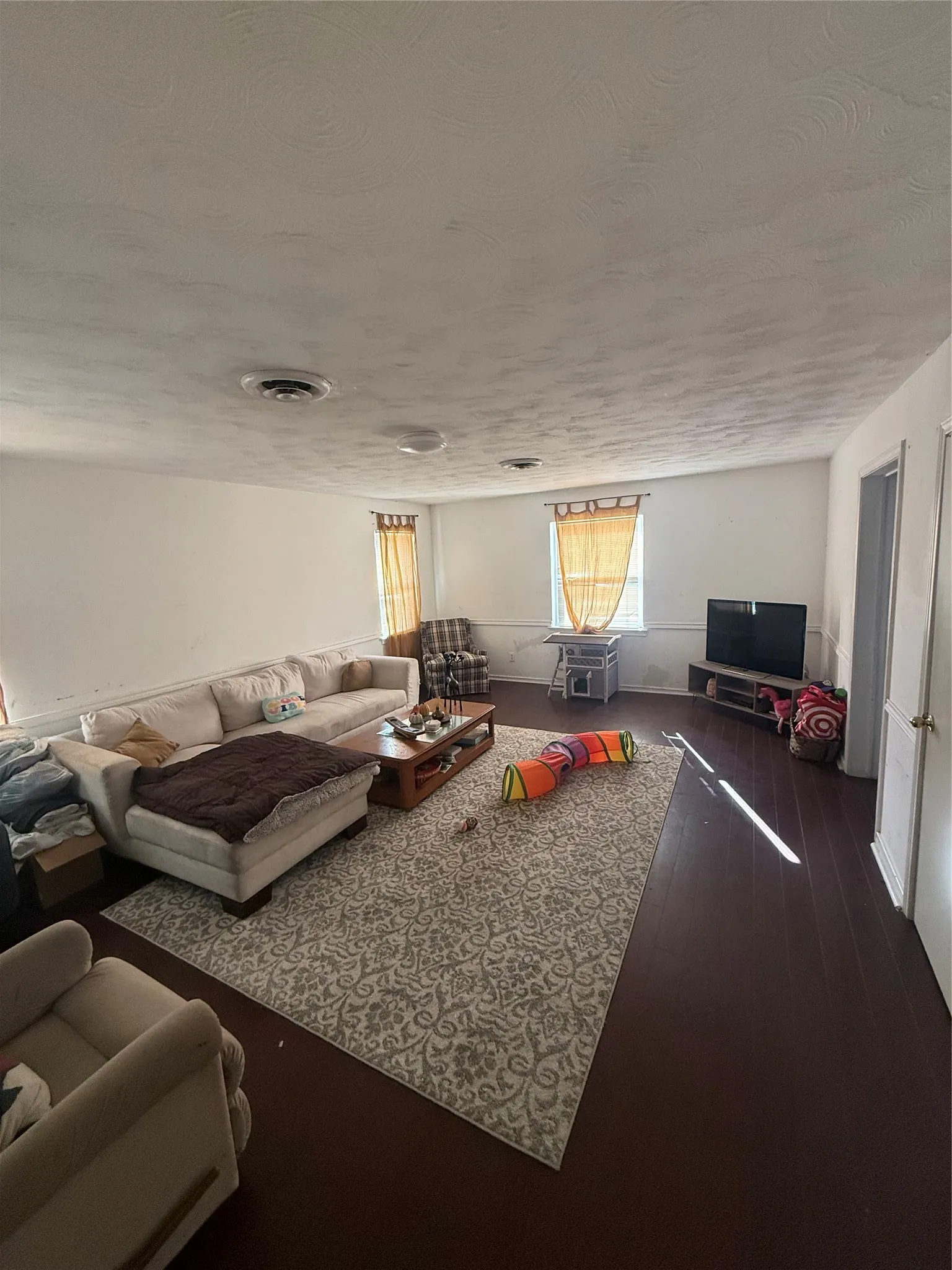 Dark wood-finish flooring complements the light wall tones