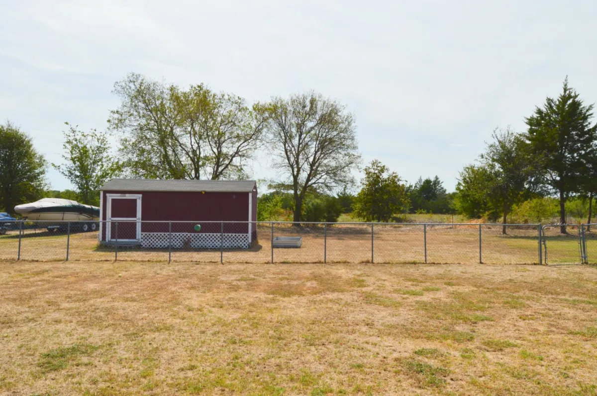The property line is the small barb wire at the second fence line