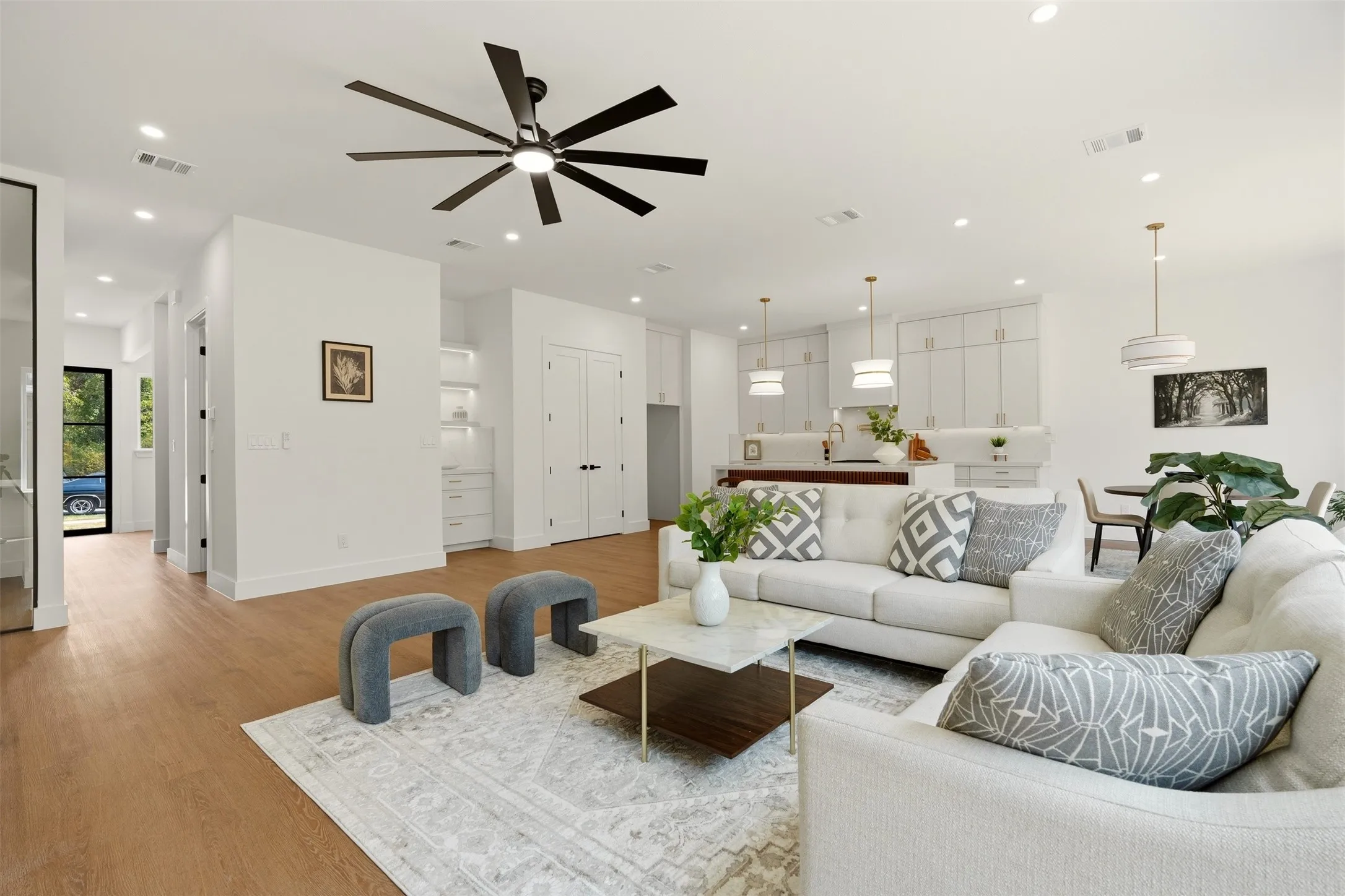 Open concept living space with recessed lighting, wood-finish flooring, and a modern ceiling fan