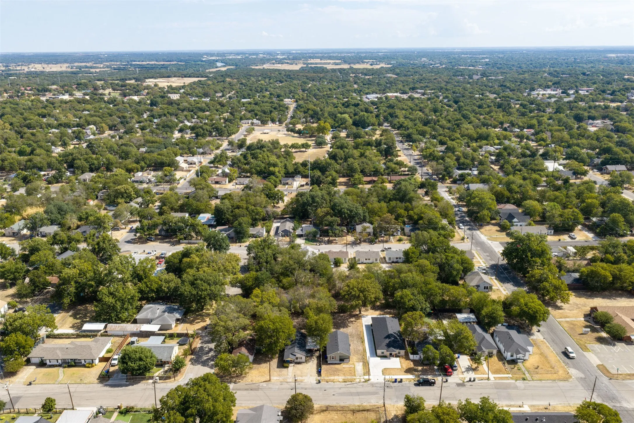 Lush, tree-lined streets with residential properties and expansive green spaces