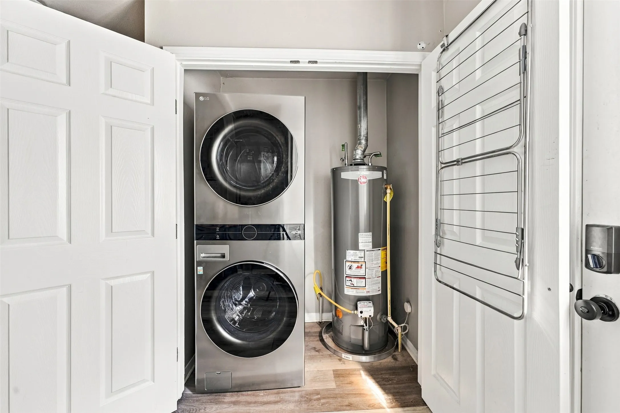 Stackable laundry appliances with a water heater, all within a dedicated closet space