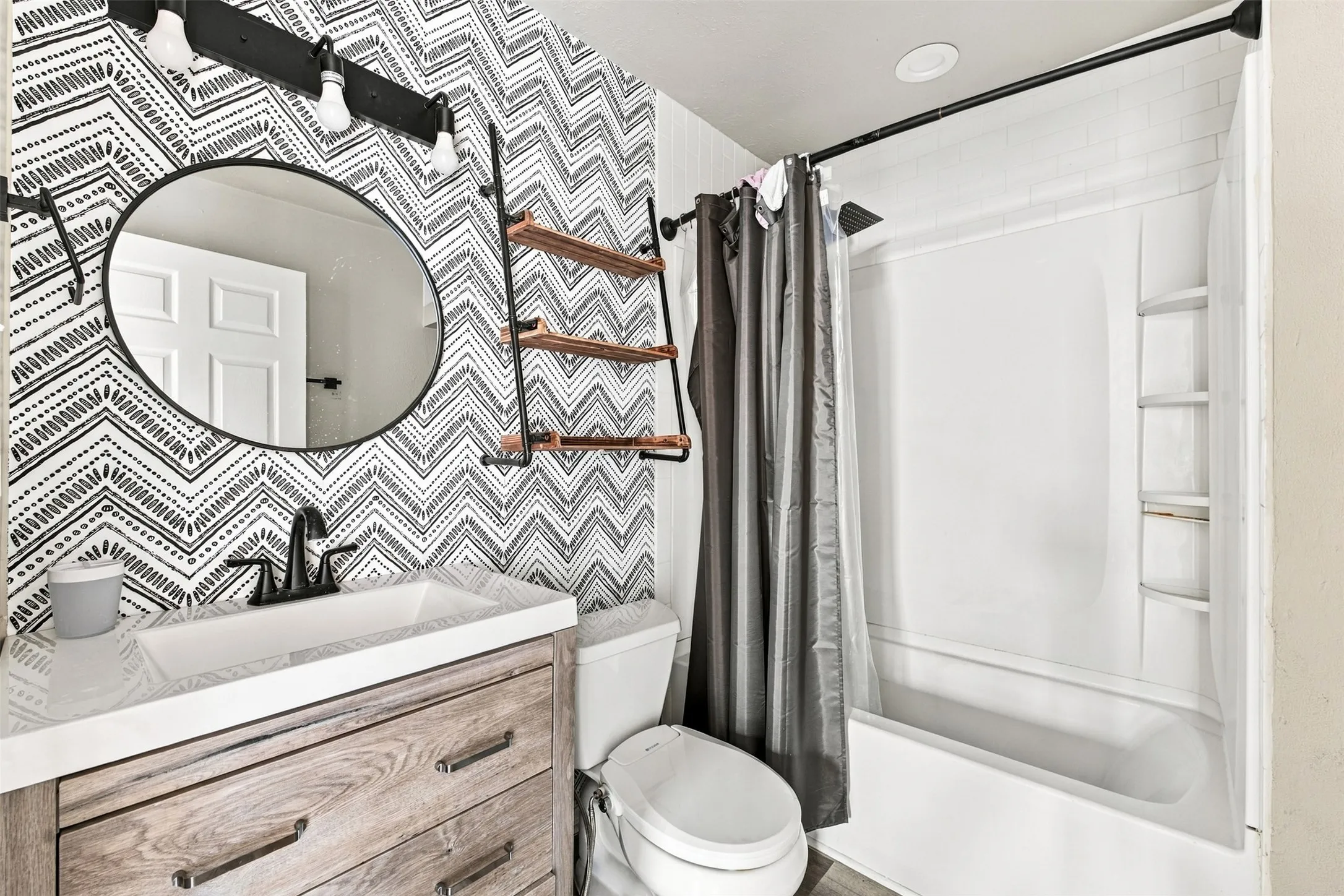 Vanity with wood-finish cabinetry, white countertop, and integrated sink