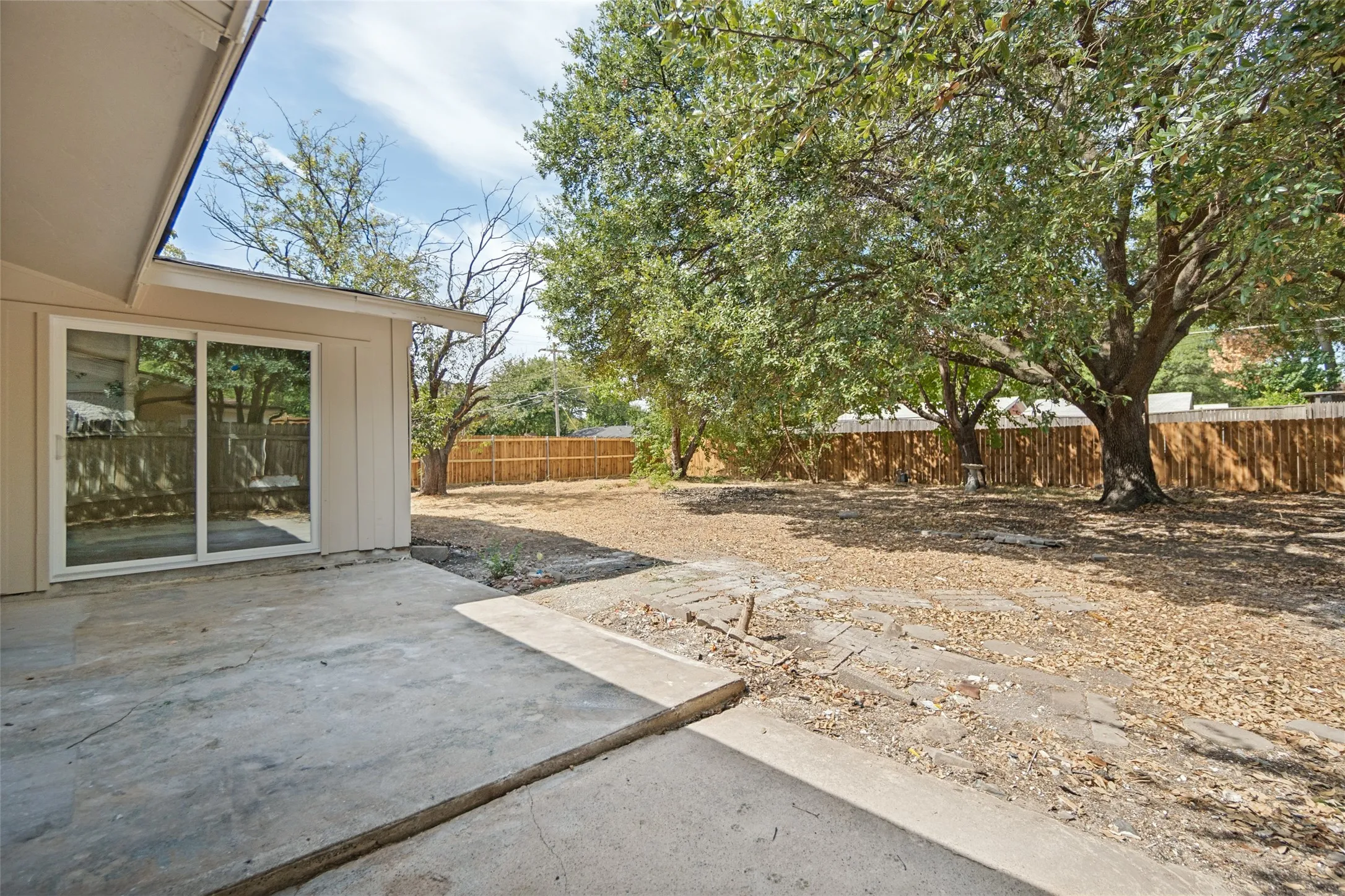 Concrete patio with sliding glass doors