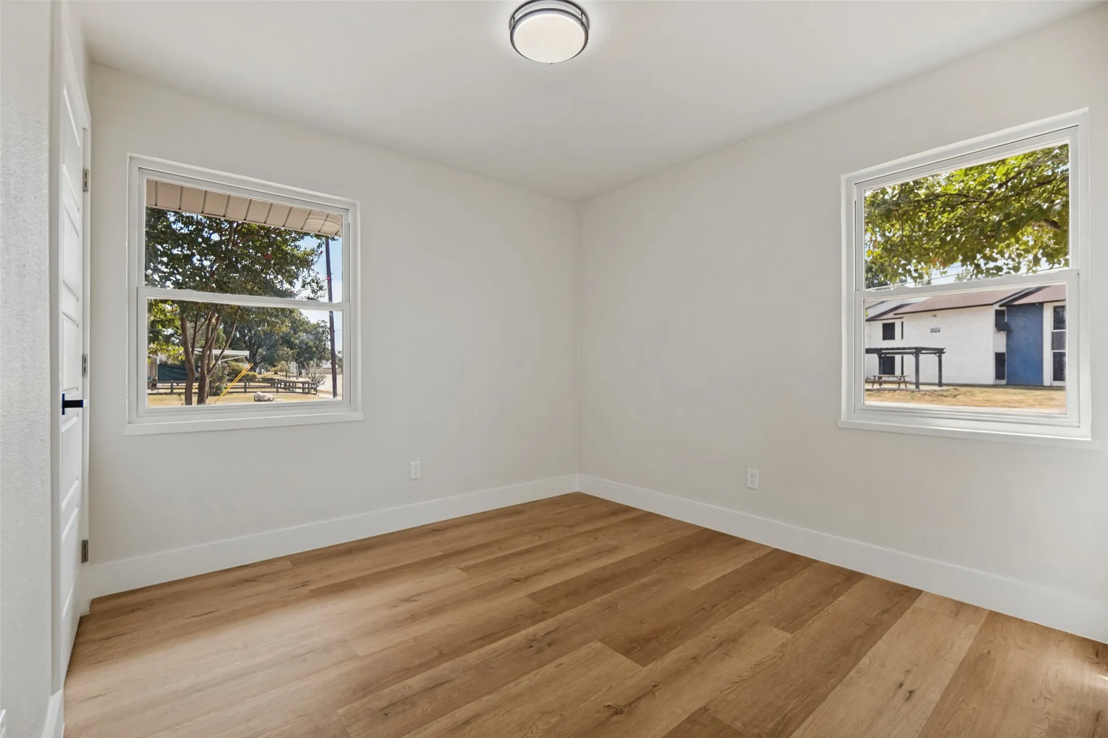 Room featuring light wood-finish flooring and white walls