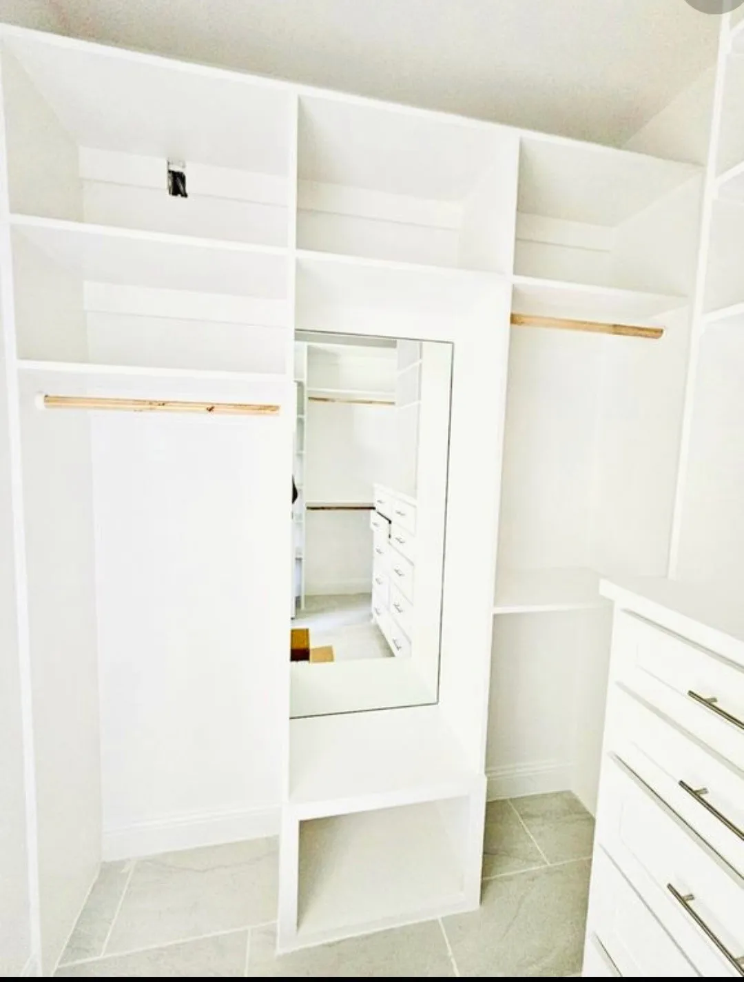 Walk in closet with light tile patterned flooring