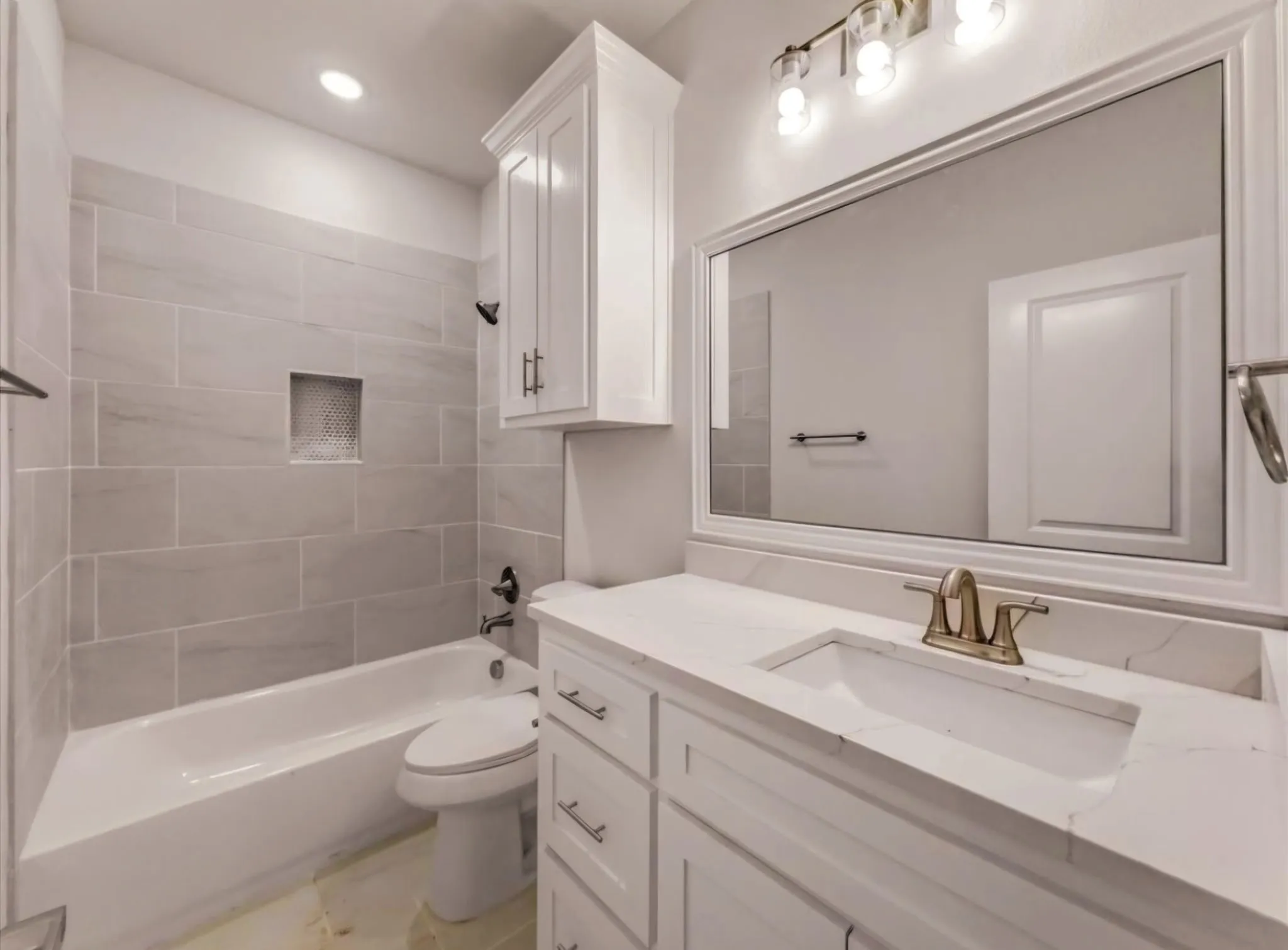 Full bathroom featuring vanity, tub / shower combination, and recessed lighting