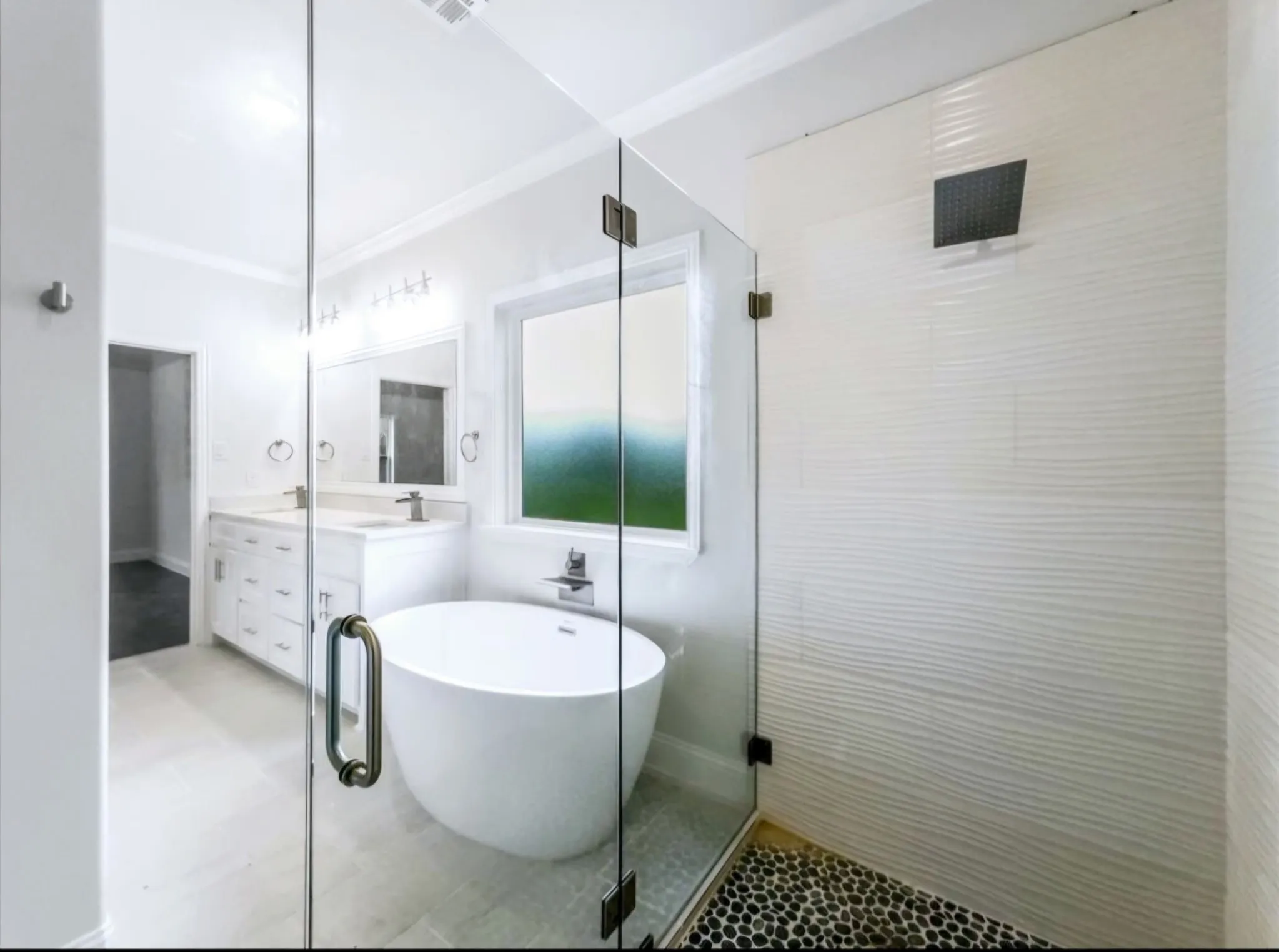 Full bath featuring ornamental molding, a freestanding bath, vanity, and a shower stall