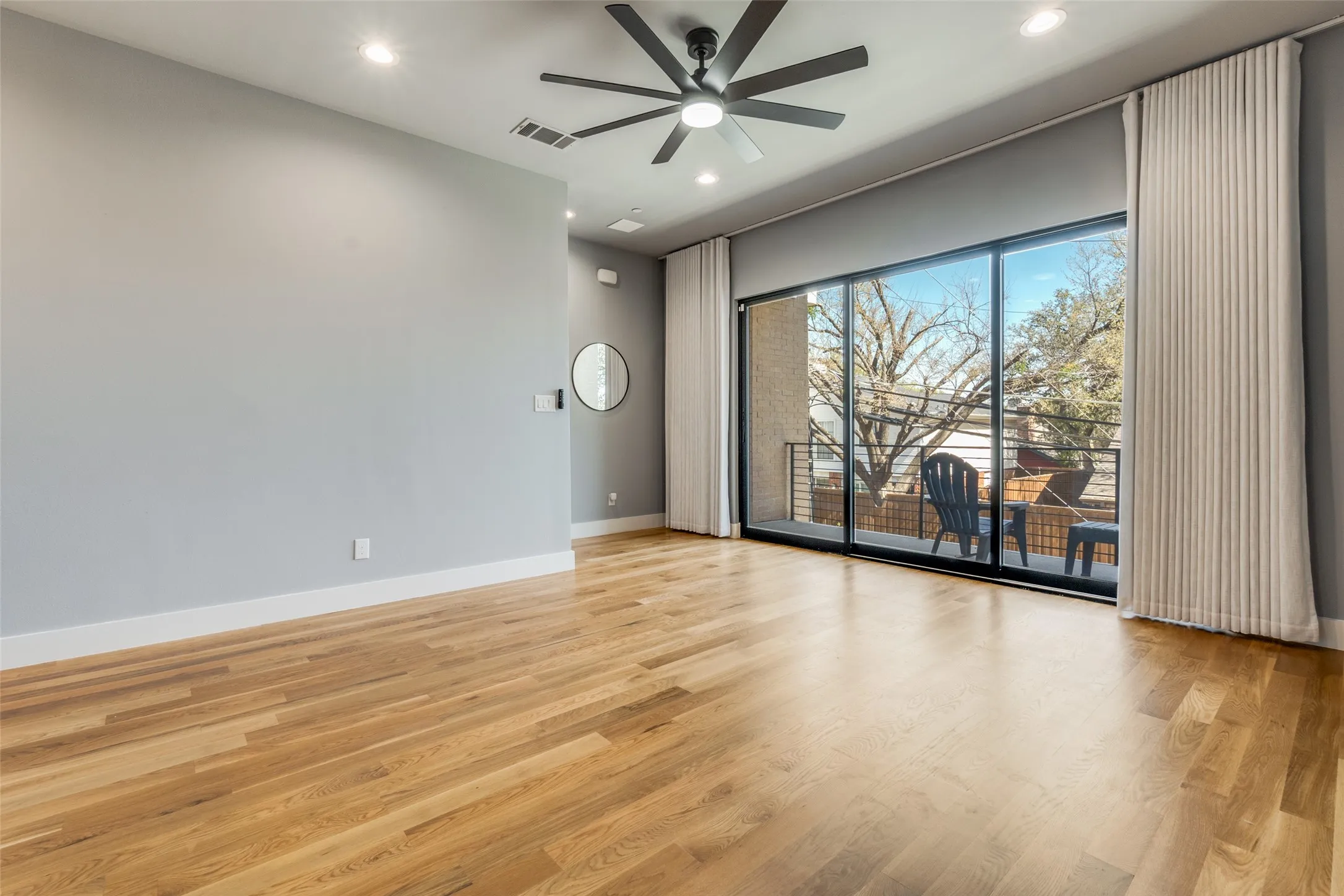 Wood-finish flooring, recessed lighting, and a ceiling fan