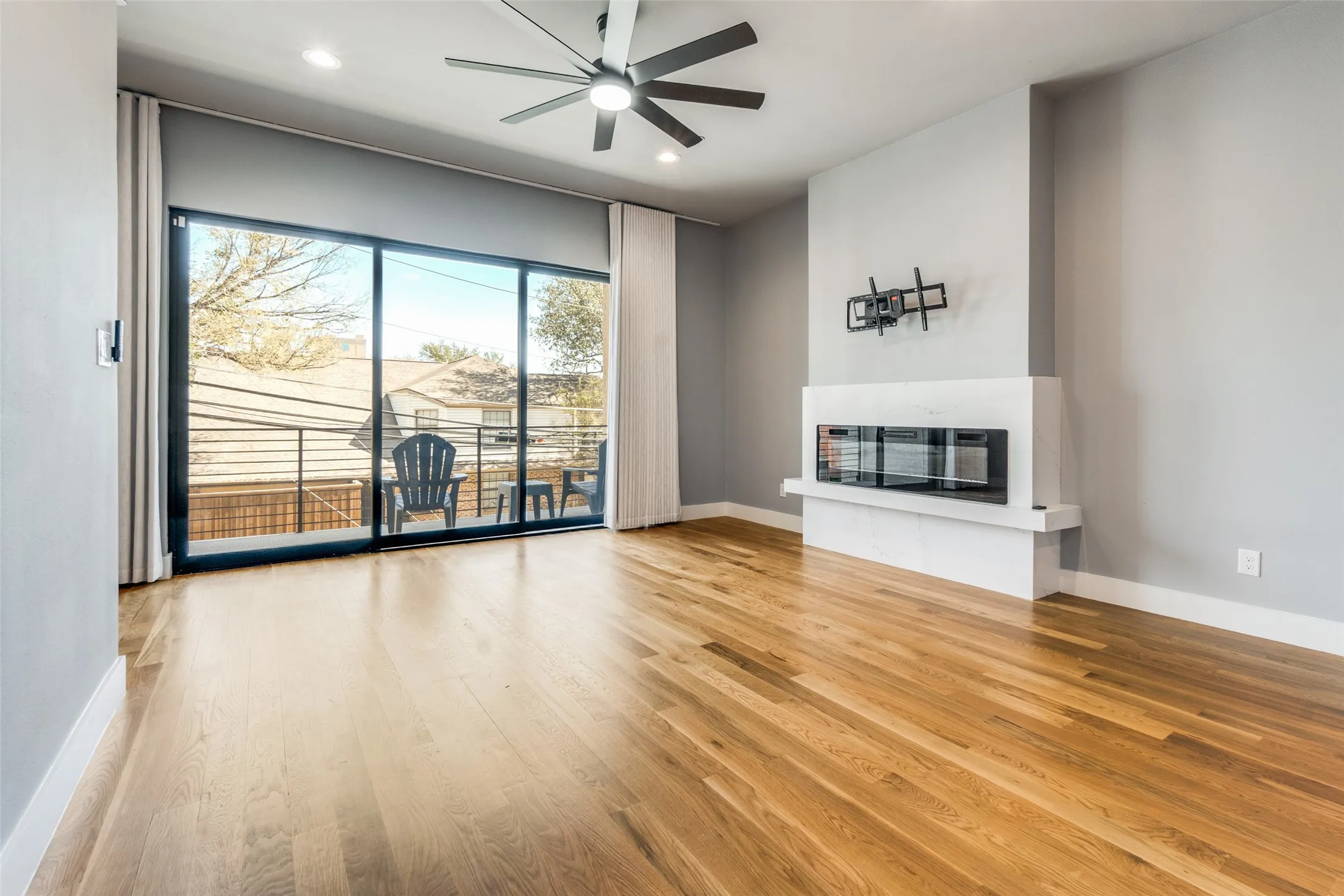 Wood-finish flooring, recessed lighting, and a ceiling fan
