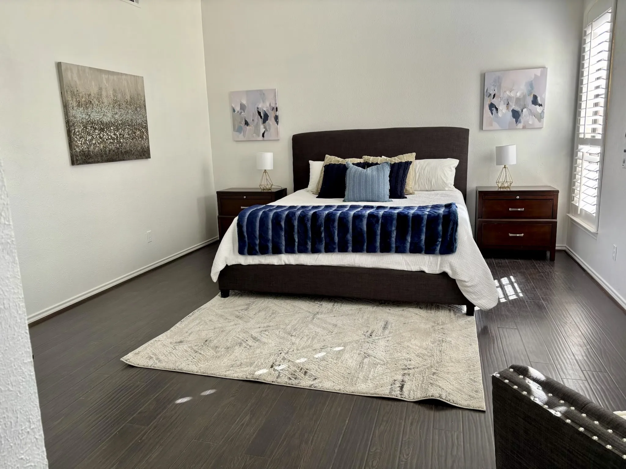 Dark wood-finish flooring with white baseboards