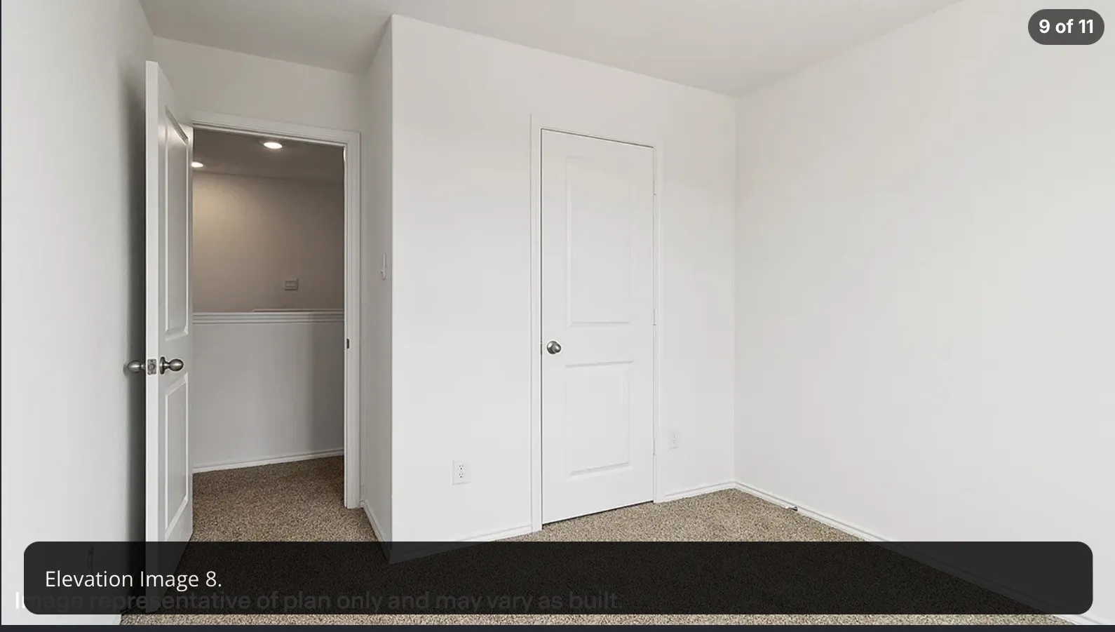 Neutral wall finish, white interior doors, and carpeted flooring