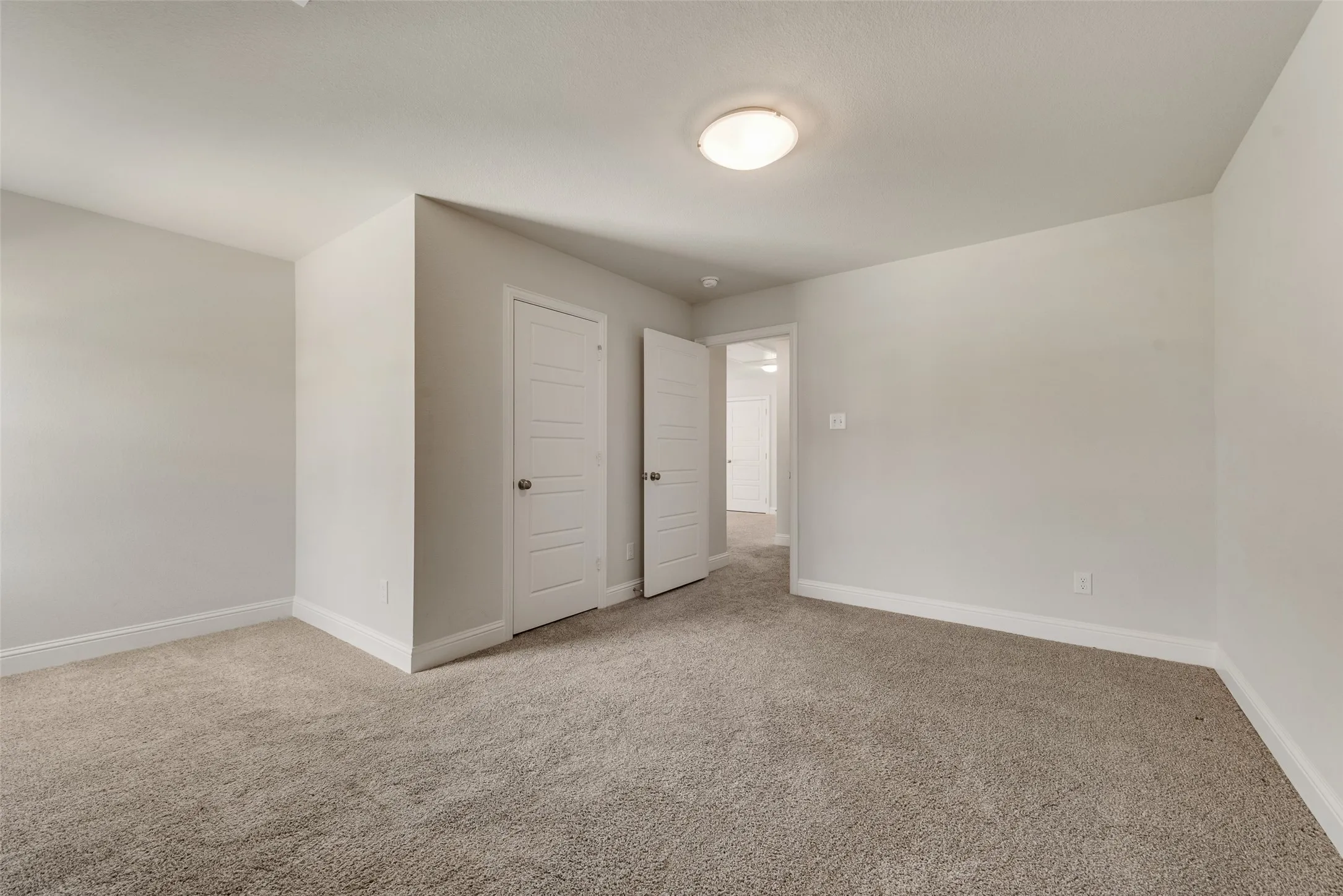 Plush carpeting and light neutral wall colors