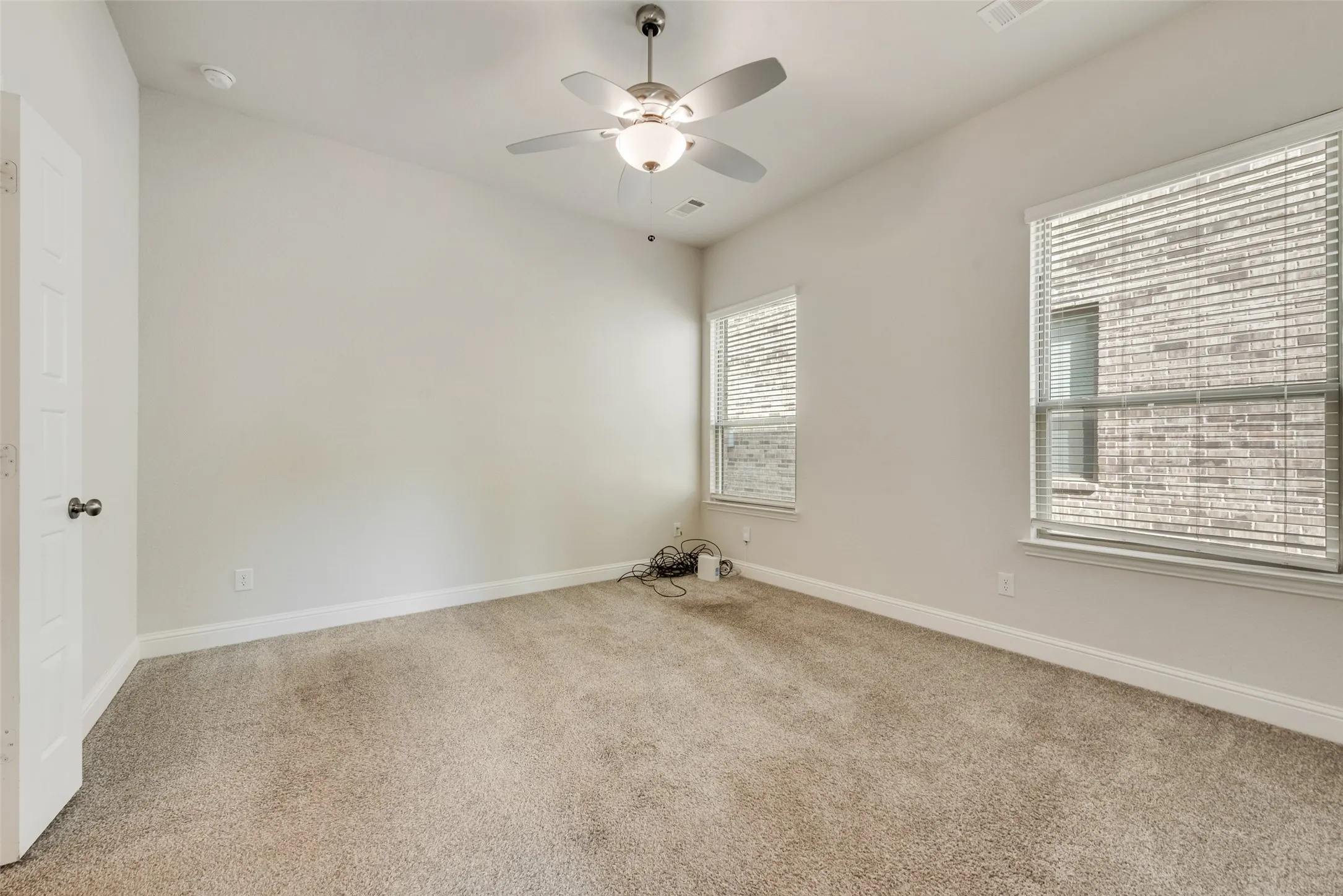 Neutral-toned walls complement plush carpeting