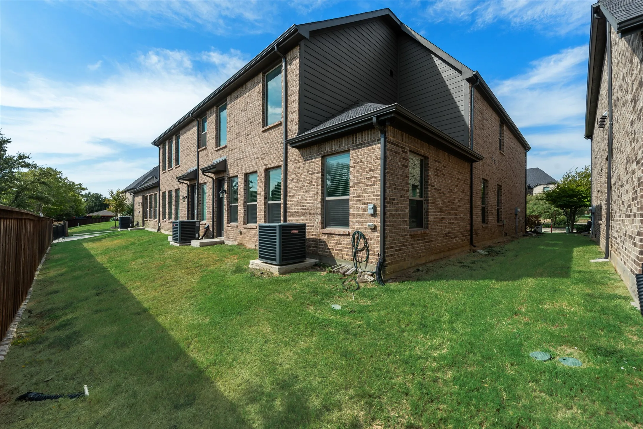 Brick exterior with dark trim and multiple windows
