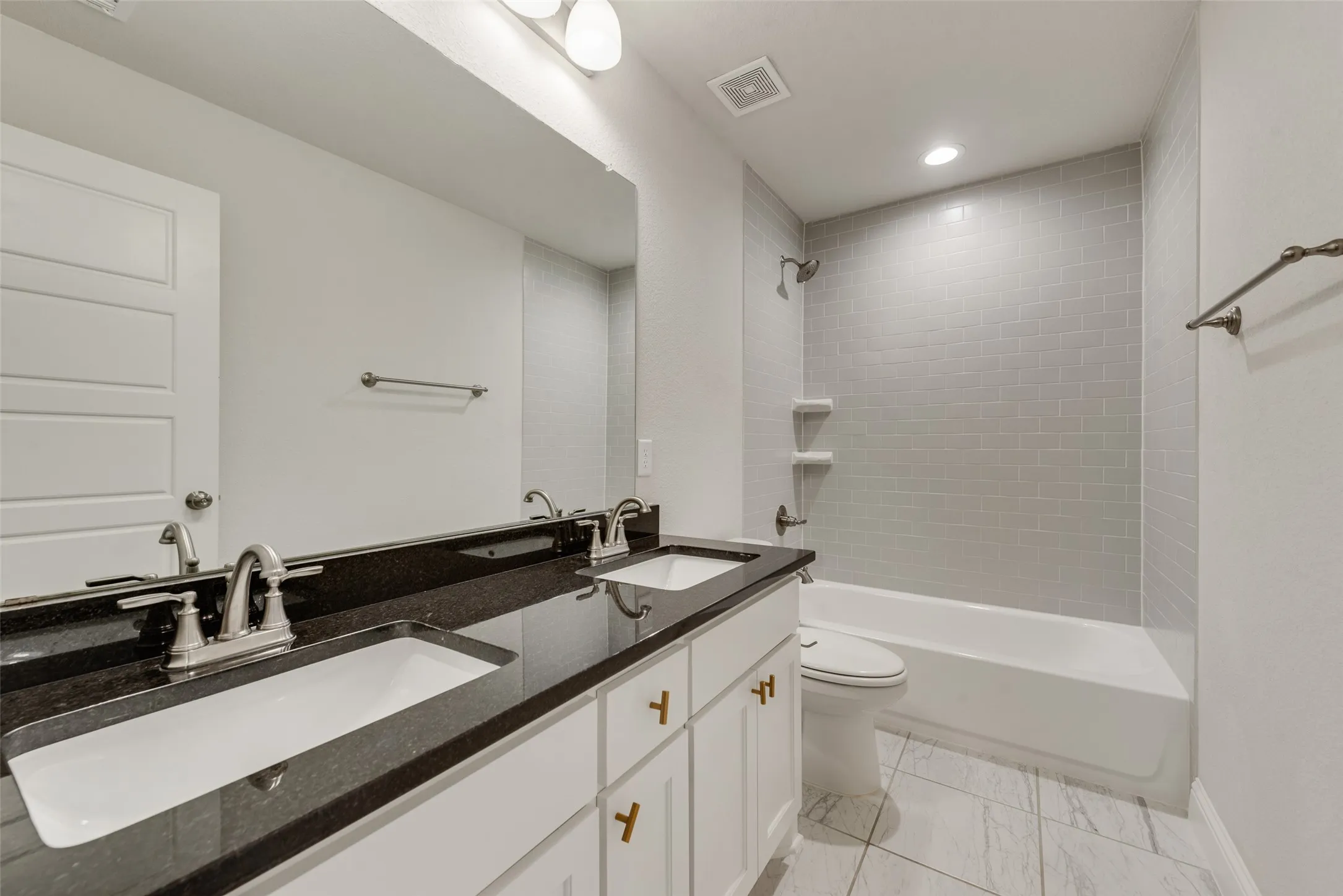 Dual vanity with integrated sinks and dark stone countertop