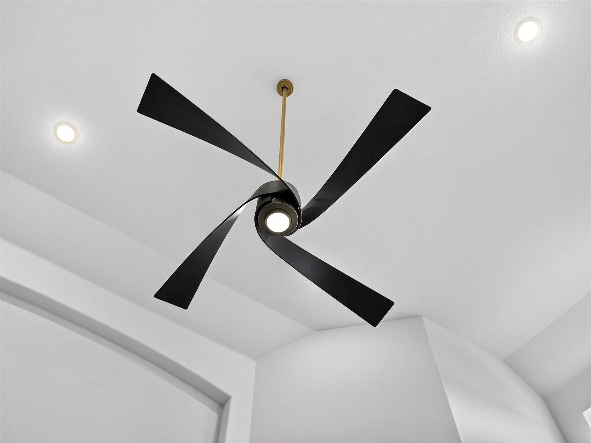 Modern ceiling fan with black blades and integrated lighting