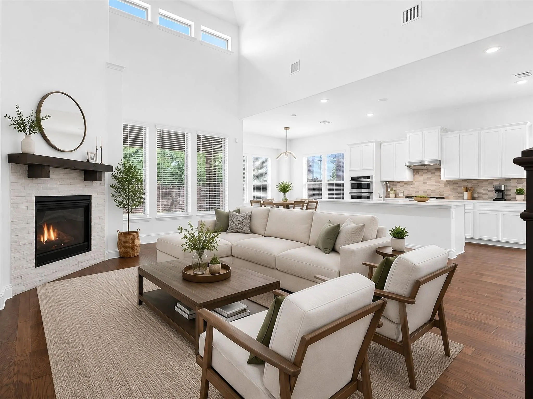 Spacious open-concept interior with high ceilings and wood-finish flooring