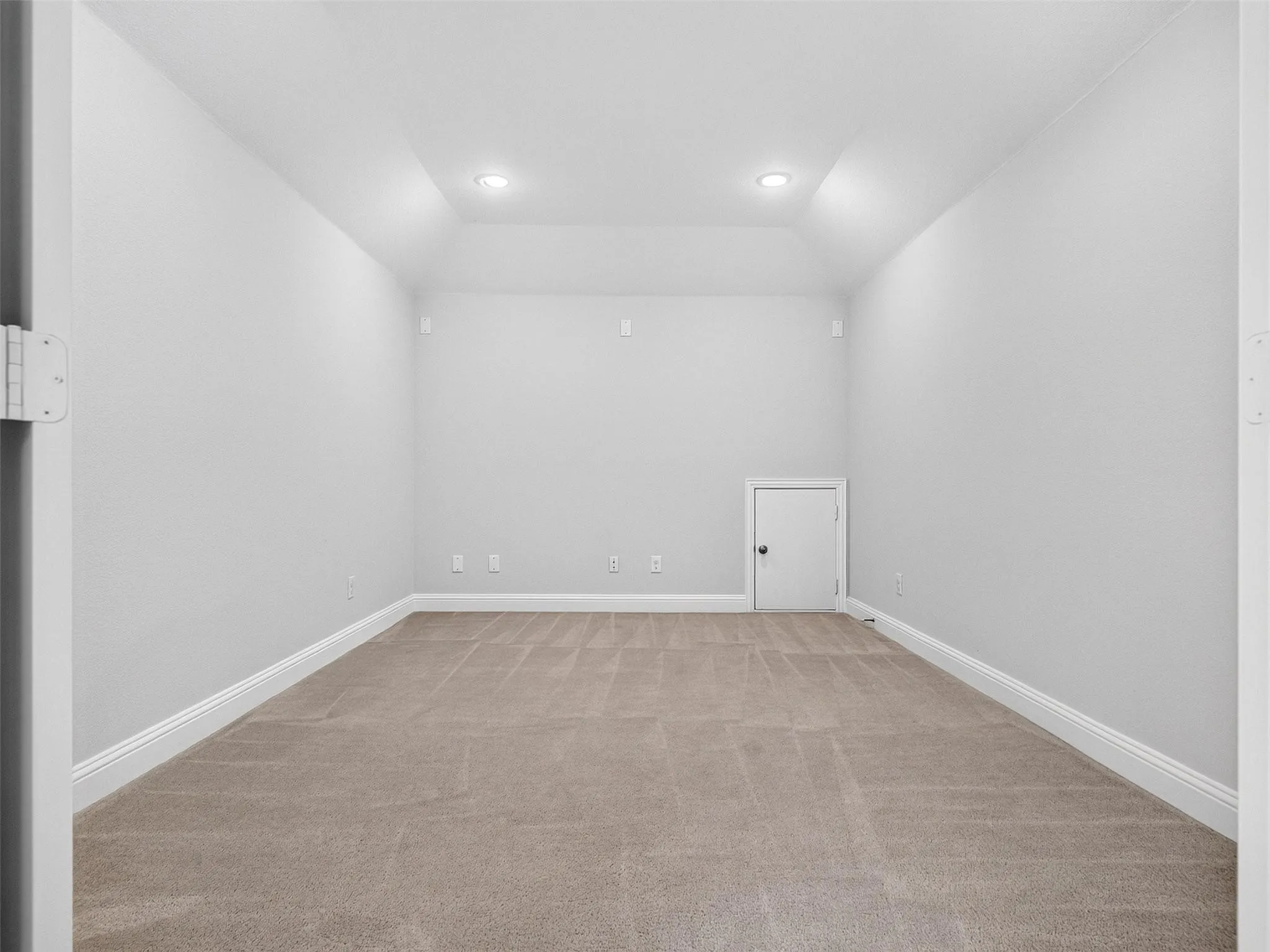 Recessed ceiling lighting, tray ceiling, neutral wall finish, neutral carpeting, white trim