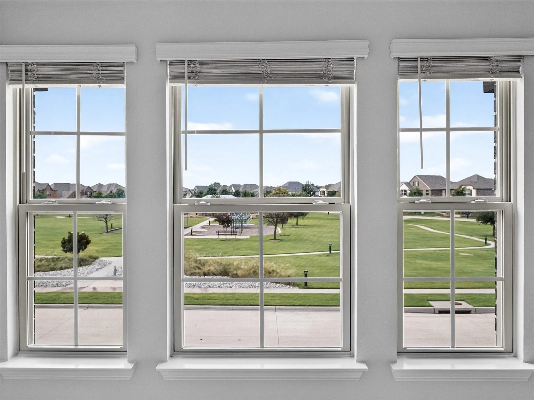 Triple windows featuring grid patterns and integrated blinds