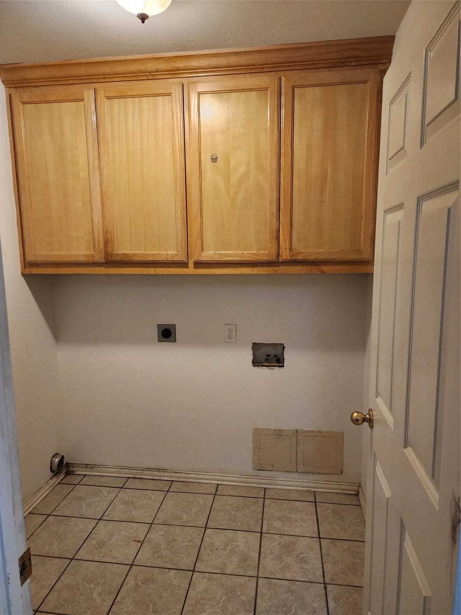 Light wood-finish cabinetry providing overhead storage