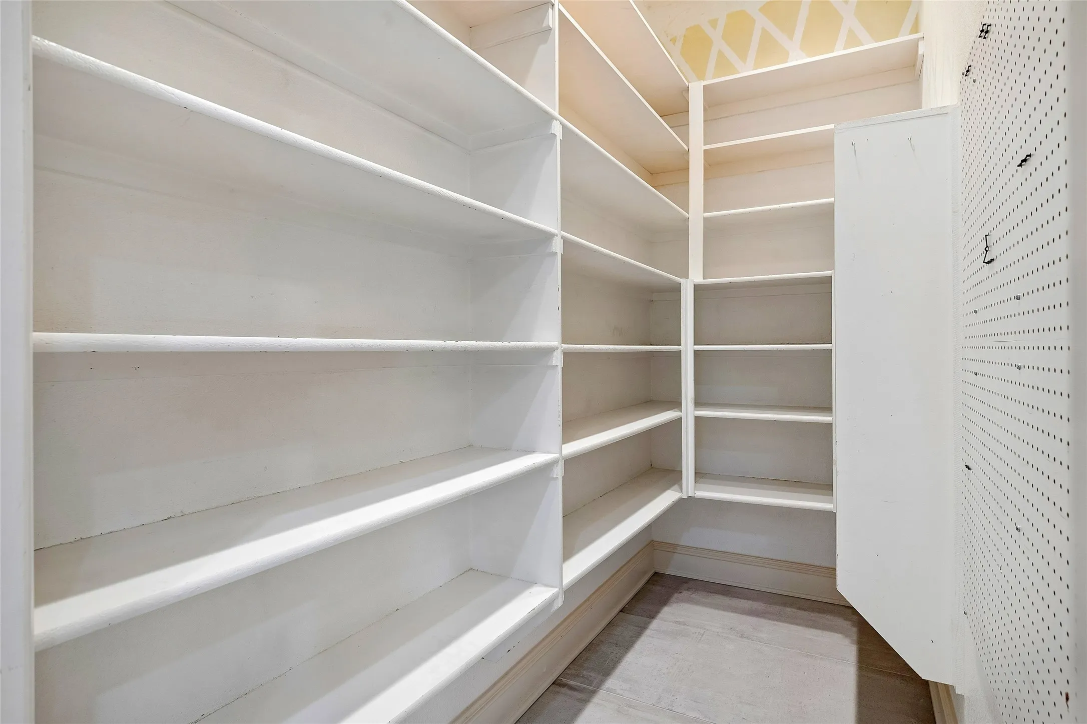 Huge pantry with wall to hang pot lids, pots, or anything.