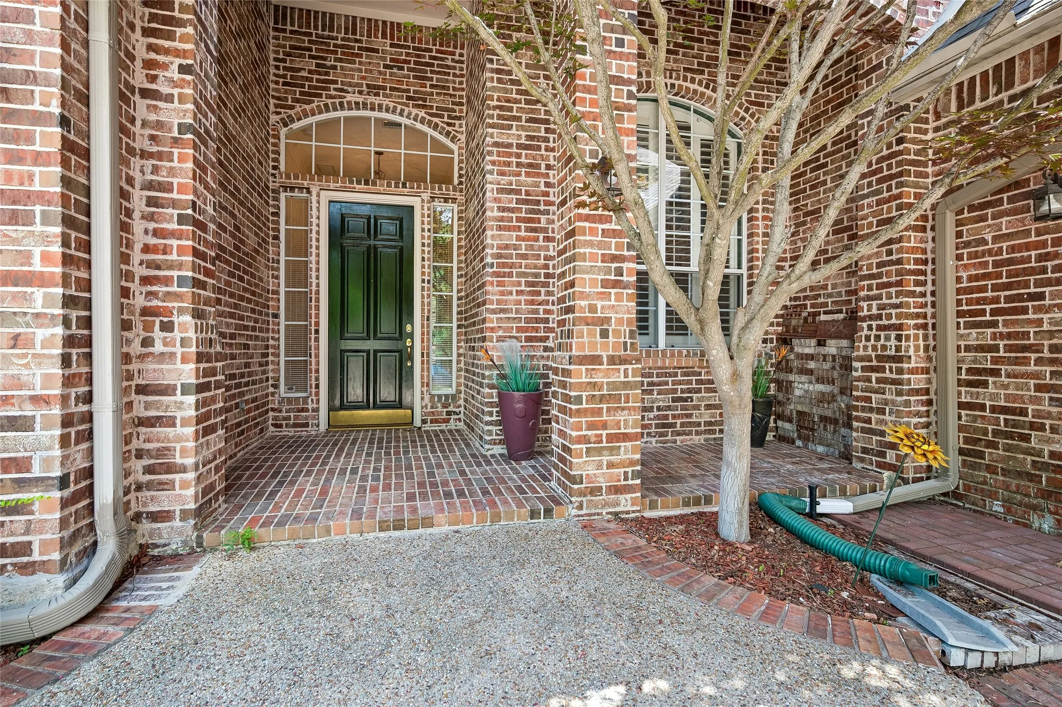 Fully bricked covered entrance and porch