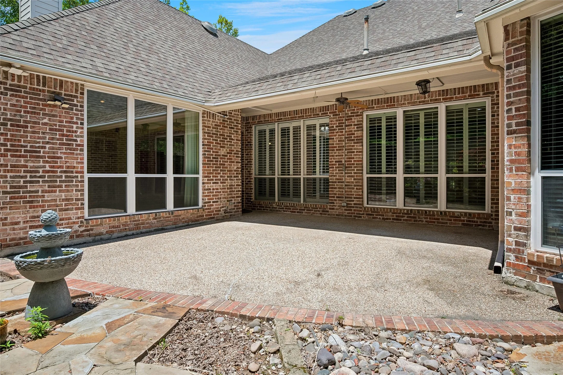 Incredible patio with ceiling fans, custom stone work, fountain.