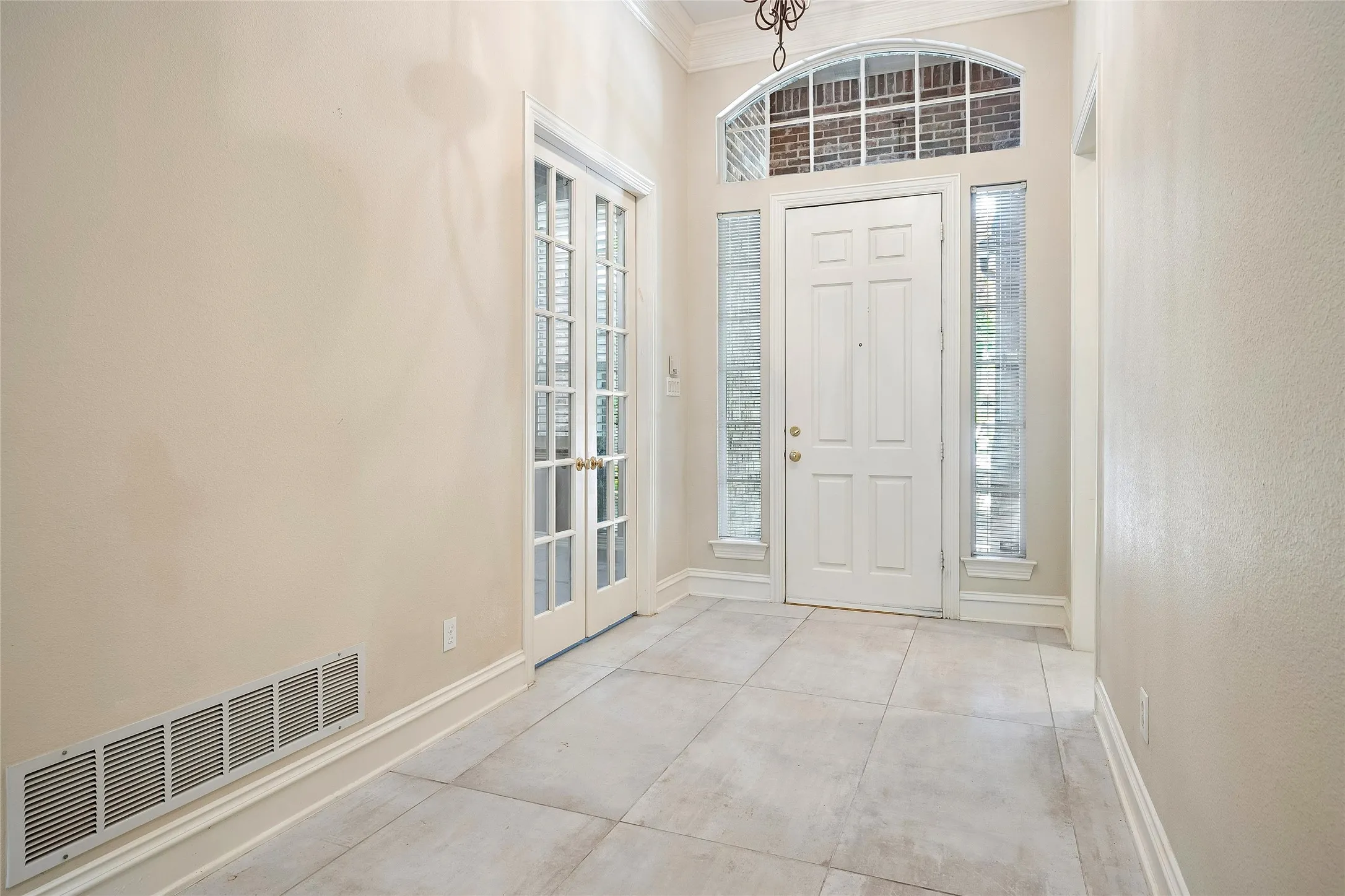 Custom tile, French doors to office or bedroom, double sidelights and eyebrow window over door.