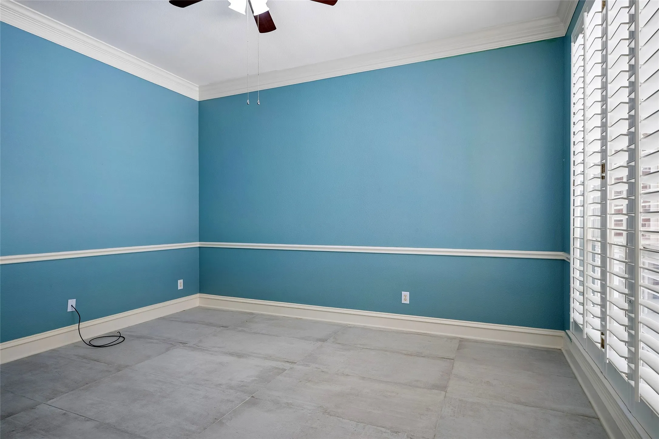 Flex room could be family room, formal dining, home gym, bedroom. Wall of windows with plantation shutters overlooks patio.