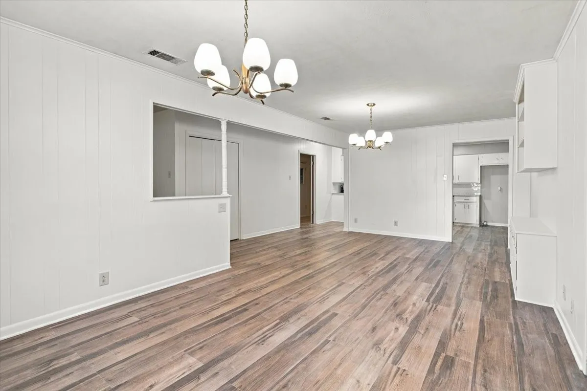 Another view of living area, dining area peering into kitchen