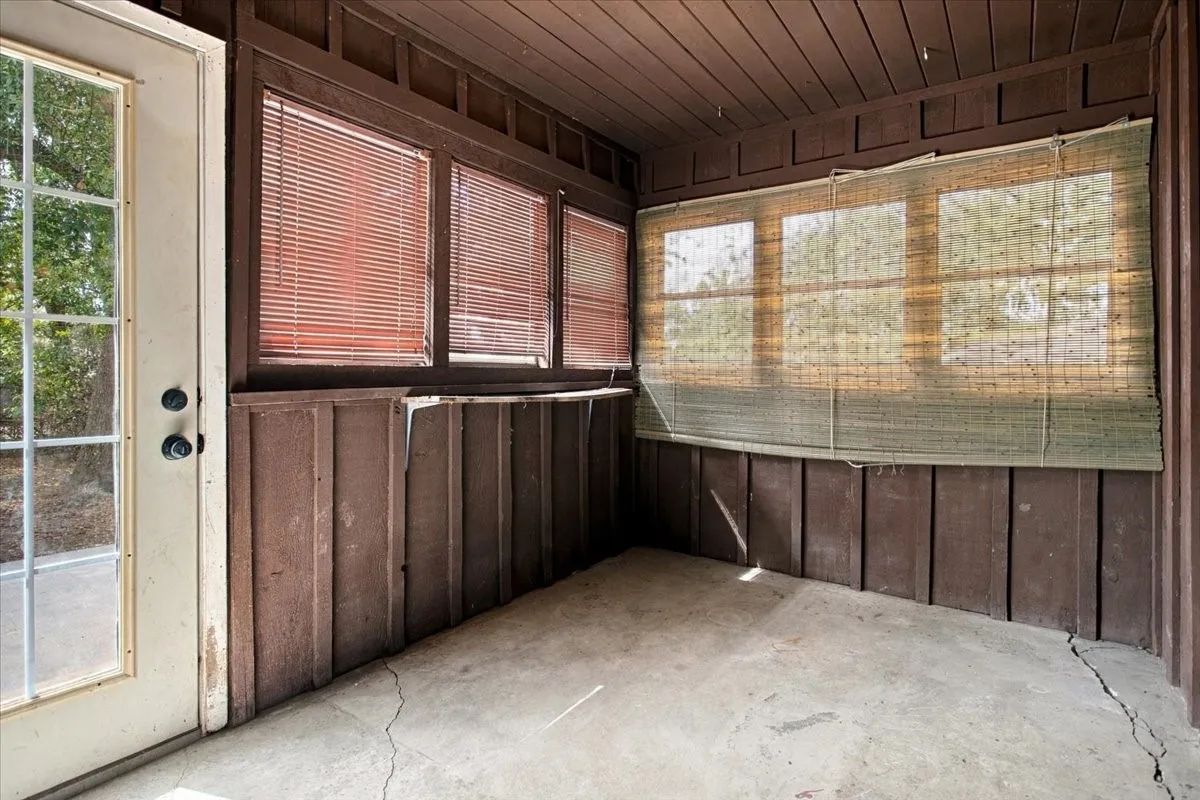 Sunroom off den leads to back yard