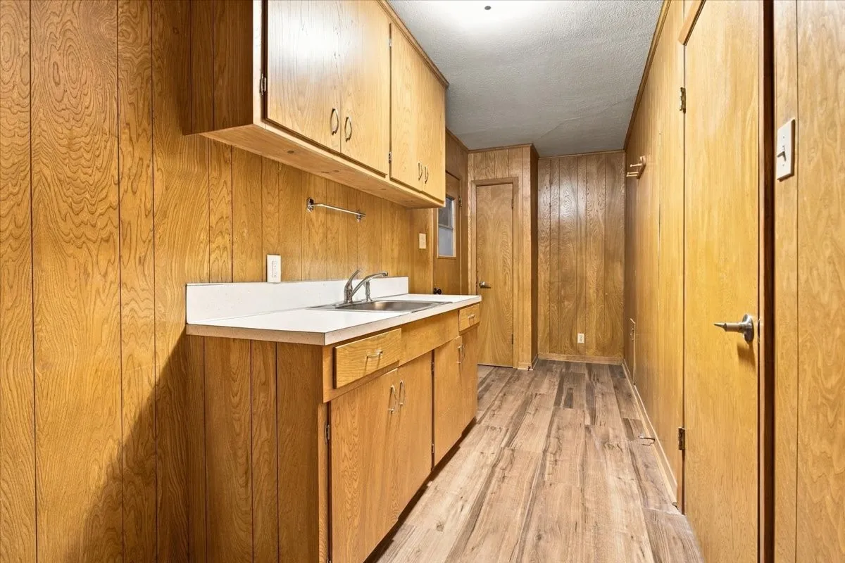 Huge 16X5+- utility room accessible from garage and close to kitchen/dining area; pantry closet,
tons of built in cabinets, sink, new vinyl plank flooring; (room for a refrigerator or freezer)