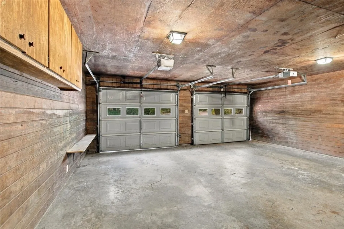 Two car garage with built in cabinets and storage room