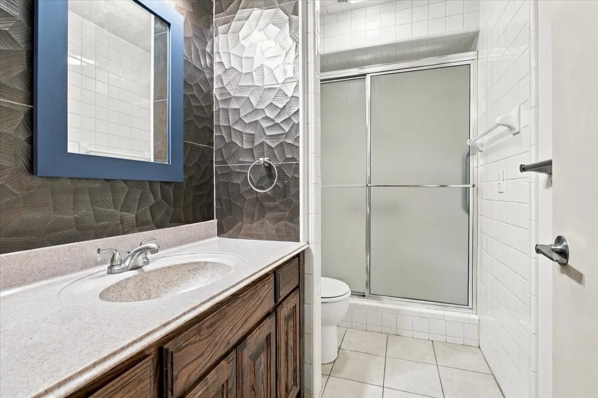 Master bathroom with lovely remodeled vanity area; separate shower/toilet area