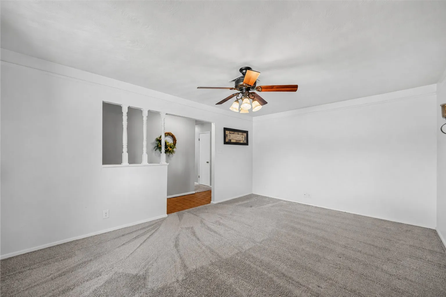 Spacious room with light gray carpet and white walls