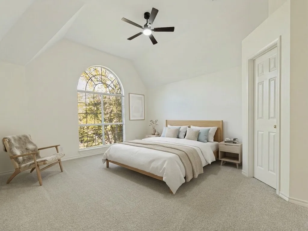Primary bedroom with virtually staged furniture.
